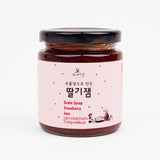 Strawberry fruit jam jar with dark red jam and black lid