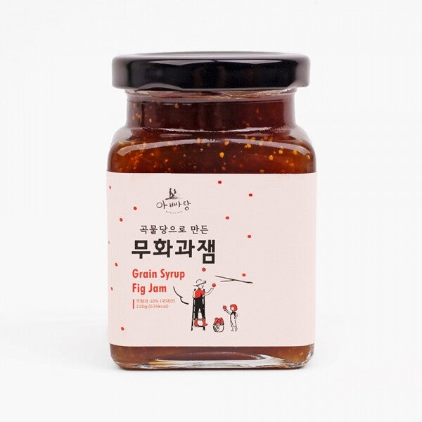 Fig fruit jam jar with dark amber-brown jam and black lid