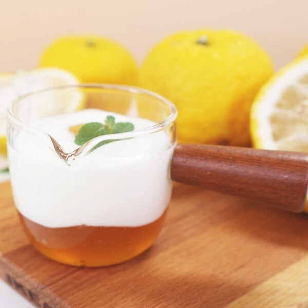 Fruit jam and yogurt in clear glass with drizzle