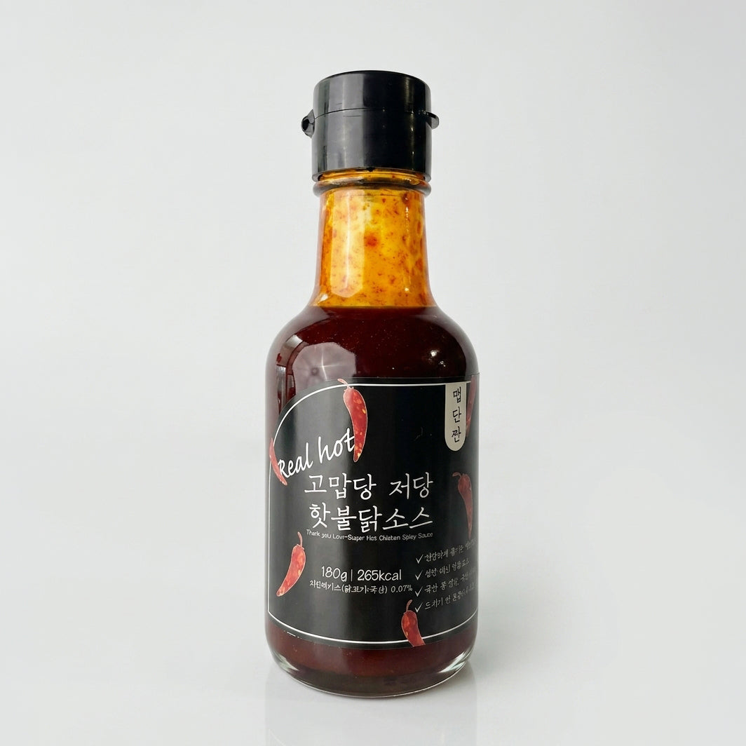 Hot buldak sauce bottle with dark brown sauce, black cap, dark label marked 'Real hot'