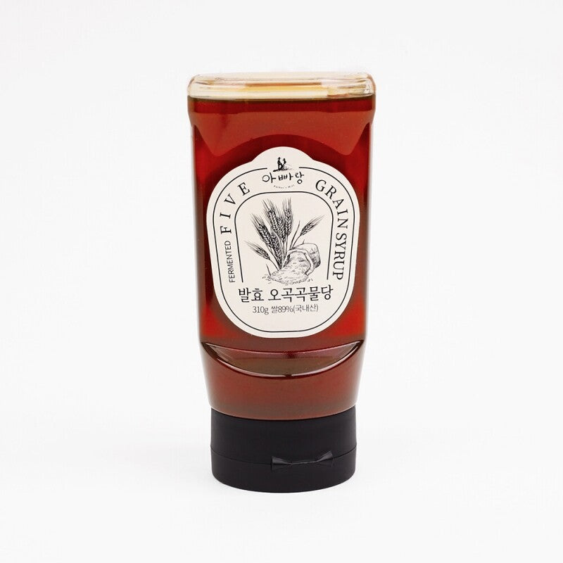 Syrup bottle with red-brown contents and white label, sealed cap and base.