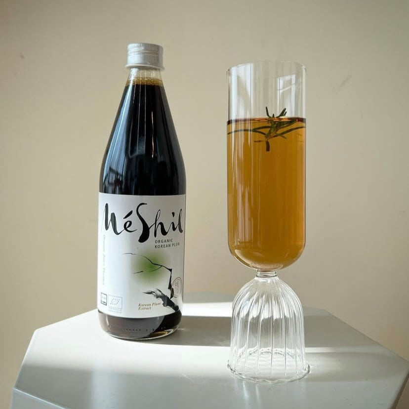 Organic Korean plum extract drink bottle with two amber glasses