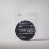 Round dark Bronzeware scrub sponge in clear plastic wrapper with label