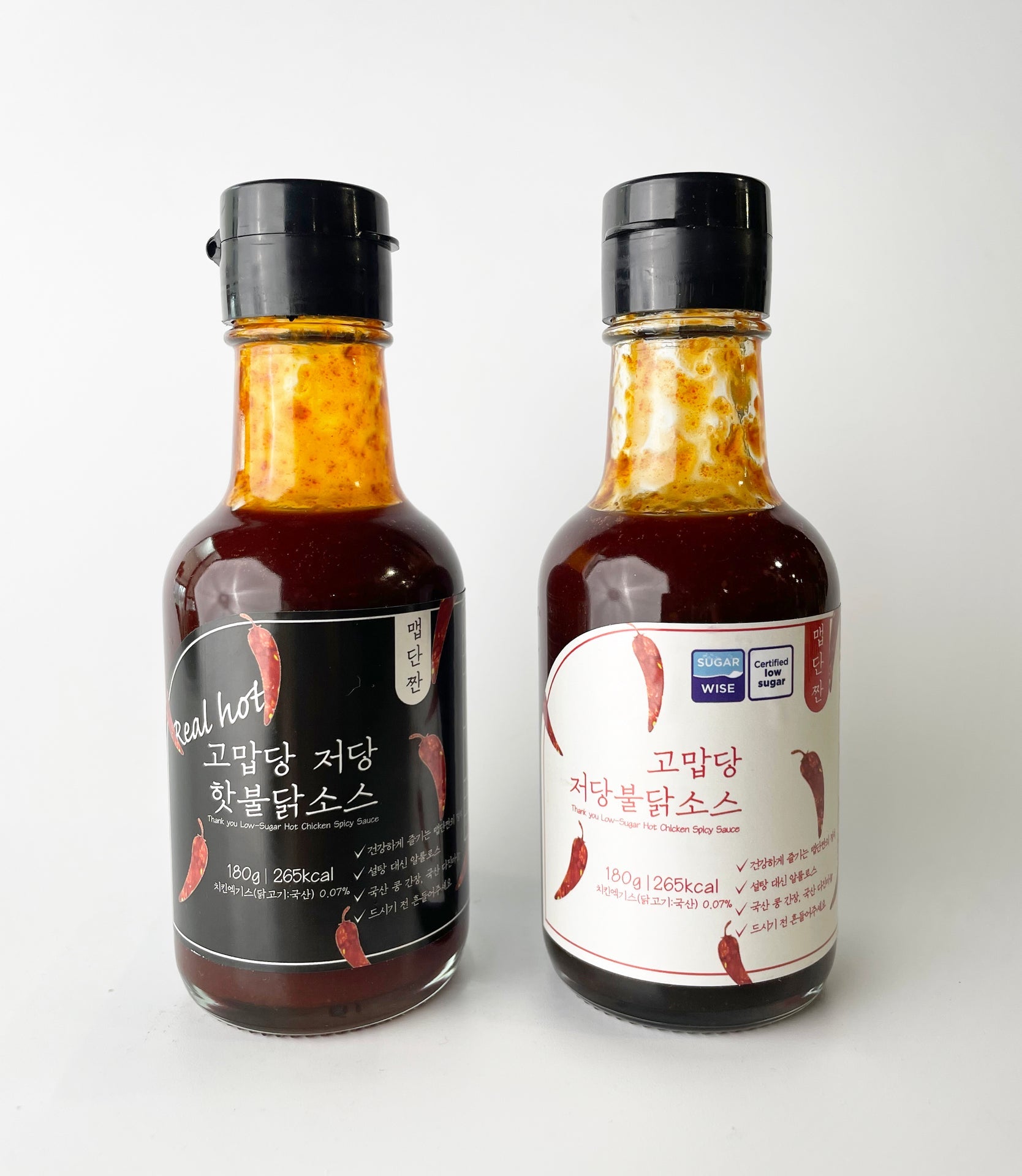 Low-sweet hot sauce bottle set with red sauce and black caps, front labels visible