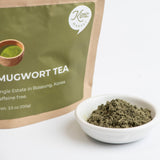 Mugwort powder (100 g) in white bowl beside labeled pouch