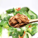 Spoonful of thick brown doenjang paste over greens