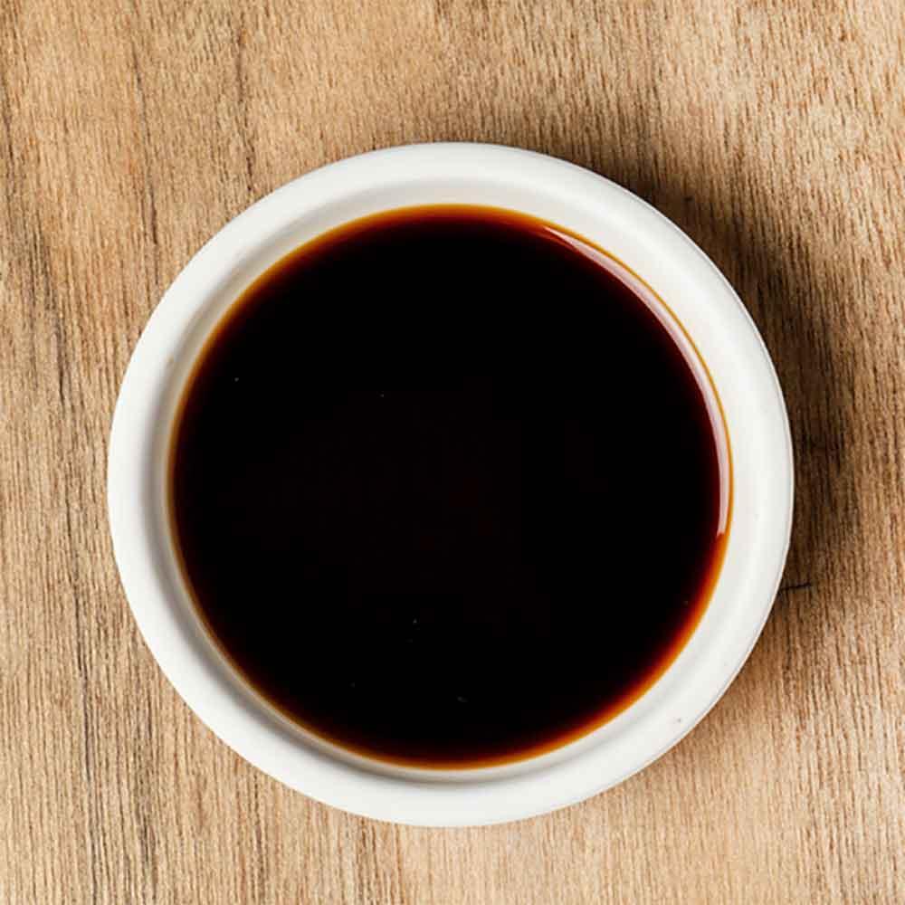 Ganjang soy sauce in white bowl, dark brown liquid