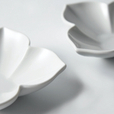 Flower-shaped ceramic dish, white, curved petal sides