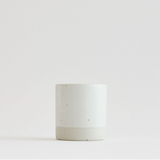 Sando shot cup, white cylindrical cup with speckled lower band.