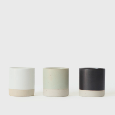 Sando shot cups, white, sage green, and black cylindrical cups.