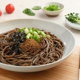 Buckwheat noodle bowl with dark perilla paste, brown seasoning, and scallions