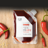 Kisoondo Traditional Gochujang pouch with red paste and chilies on wooden surface
