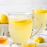 Glass mugs with pale yellow lemon cheong beverage and lemon slices