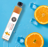 Tangerine vinegar bottle with black cap and white label