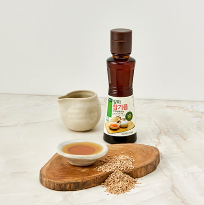 Extra virgin sprouted sesame oil bottle with amber liquid and paper label