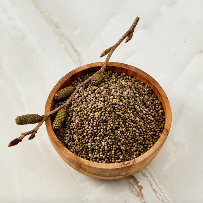 Sprouted perilla seeds in a round wooden bowl with stems