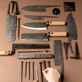 Set of knives with wooden handles and metal blades laid flat.