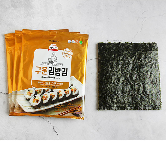 Roasted gimbap laver sheet and package on a light background, dark green square