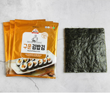 Roasted gimbap laver sheet and package on a light background, dark green square
