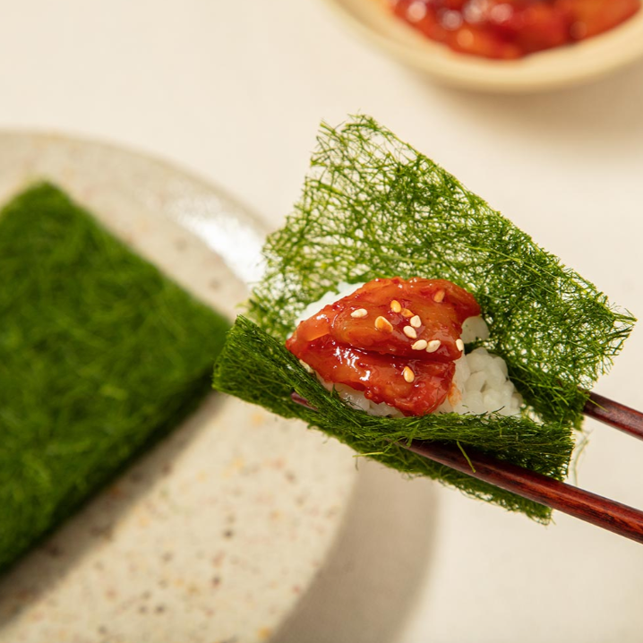 Gamtae seaweed square with red topping and white sesame on rice