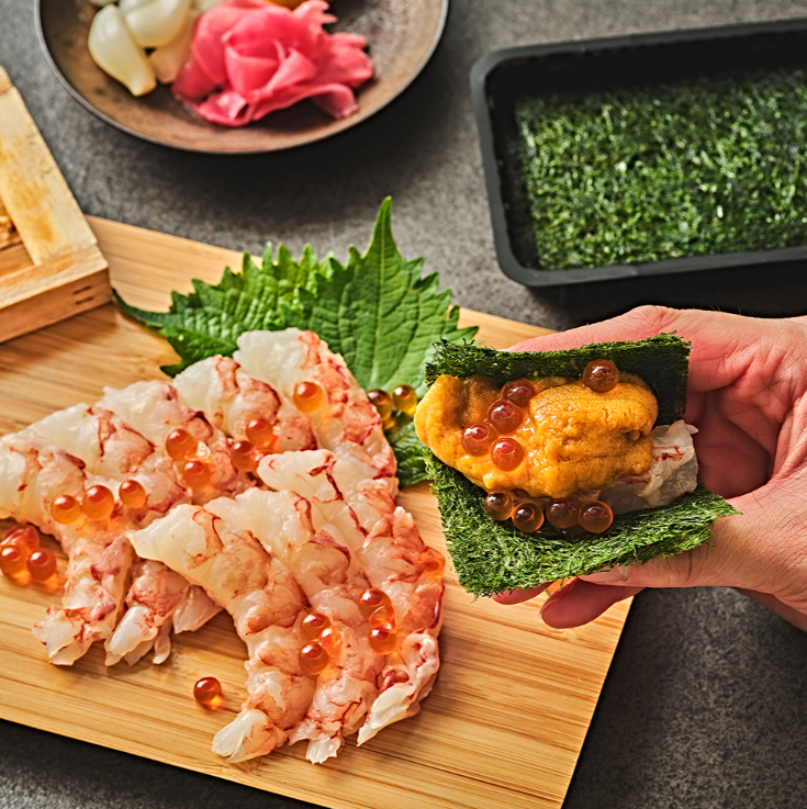 Gamtae seaweed snack sheets, one held in hand with filling and herbs