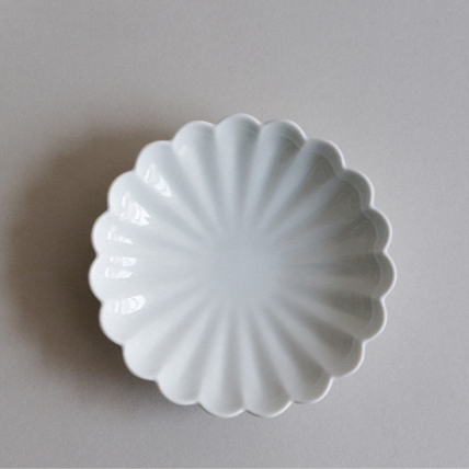 White flower-shaped side dish plate with scalloped petals