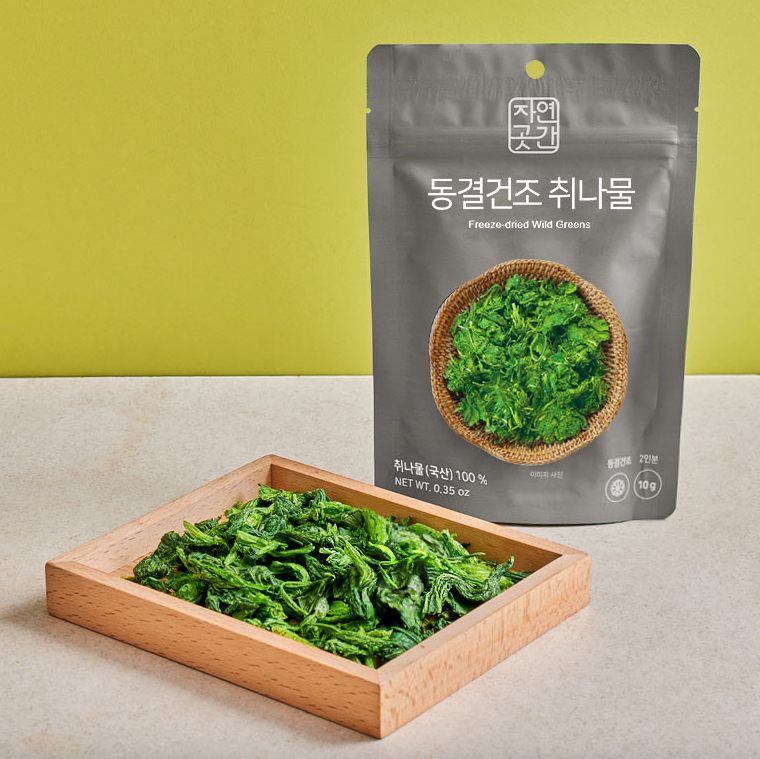 Freeze-dried wild greens namul pouch with a wooden tray of dried greens