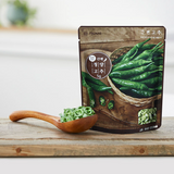 Sliced chili pepper pouch with wooden spoon and green pepper slices