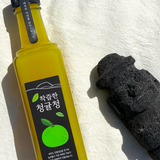 Jeju green tangerine extract bottle with yellow liquid and black cap