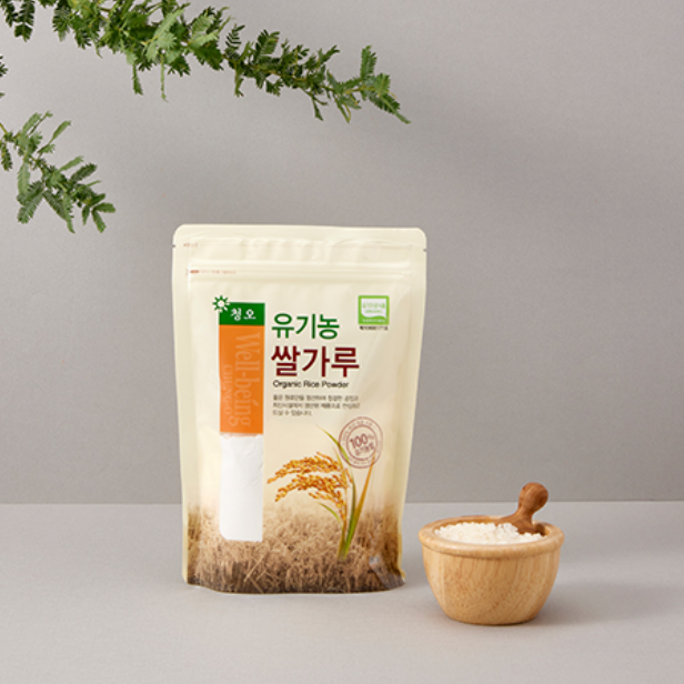 Organic rice flour pouch with rice flour in a wooden bowl