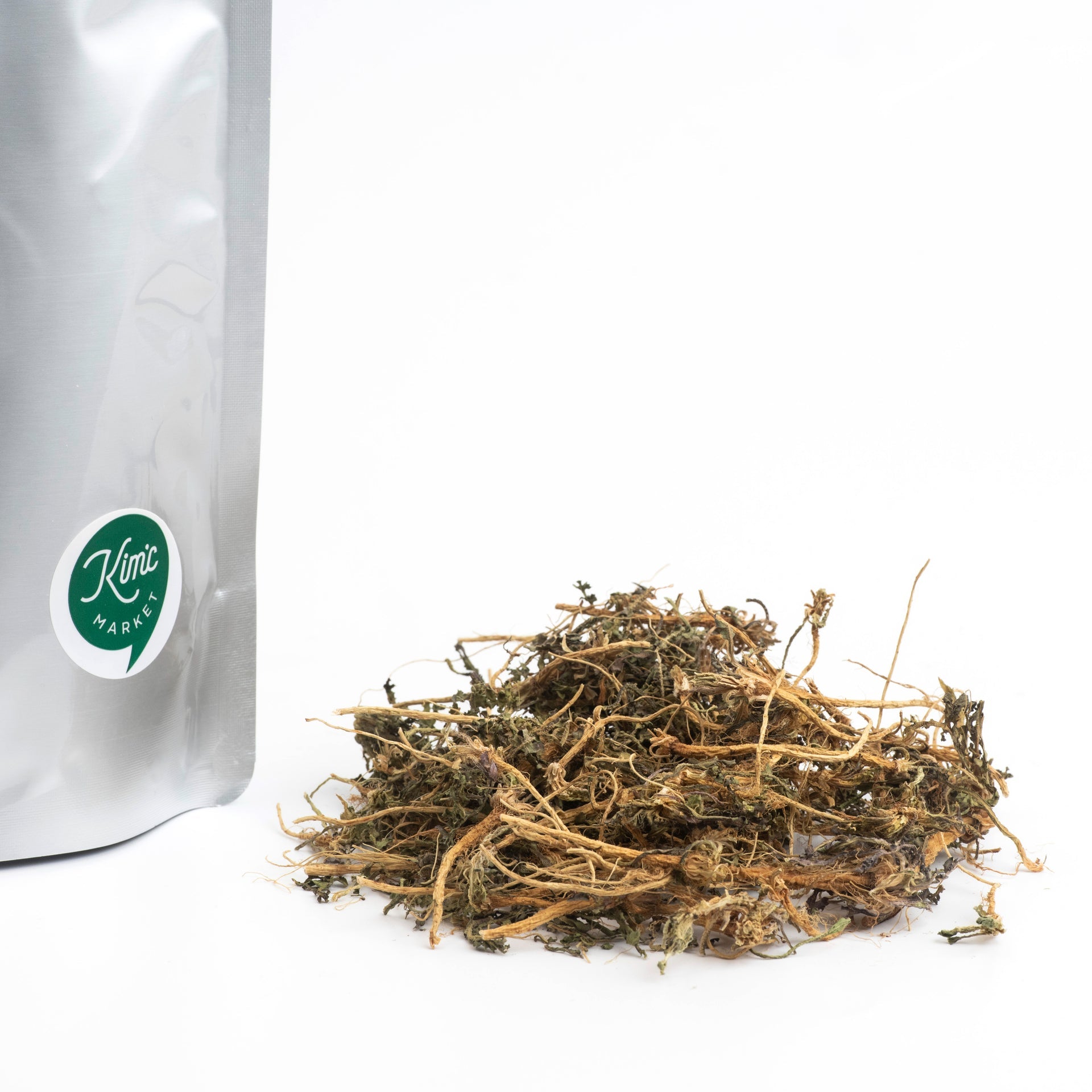 Dried shepherd's purse pouch beside mound of dried herb stems and leaves