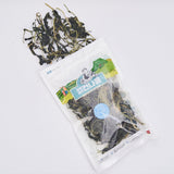 Dried chwi-namul pouch with dark twisted roots and greens scattered
