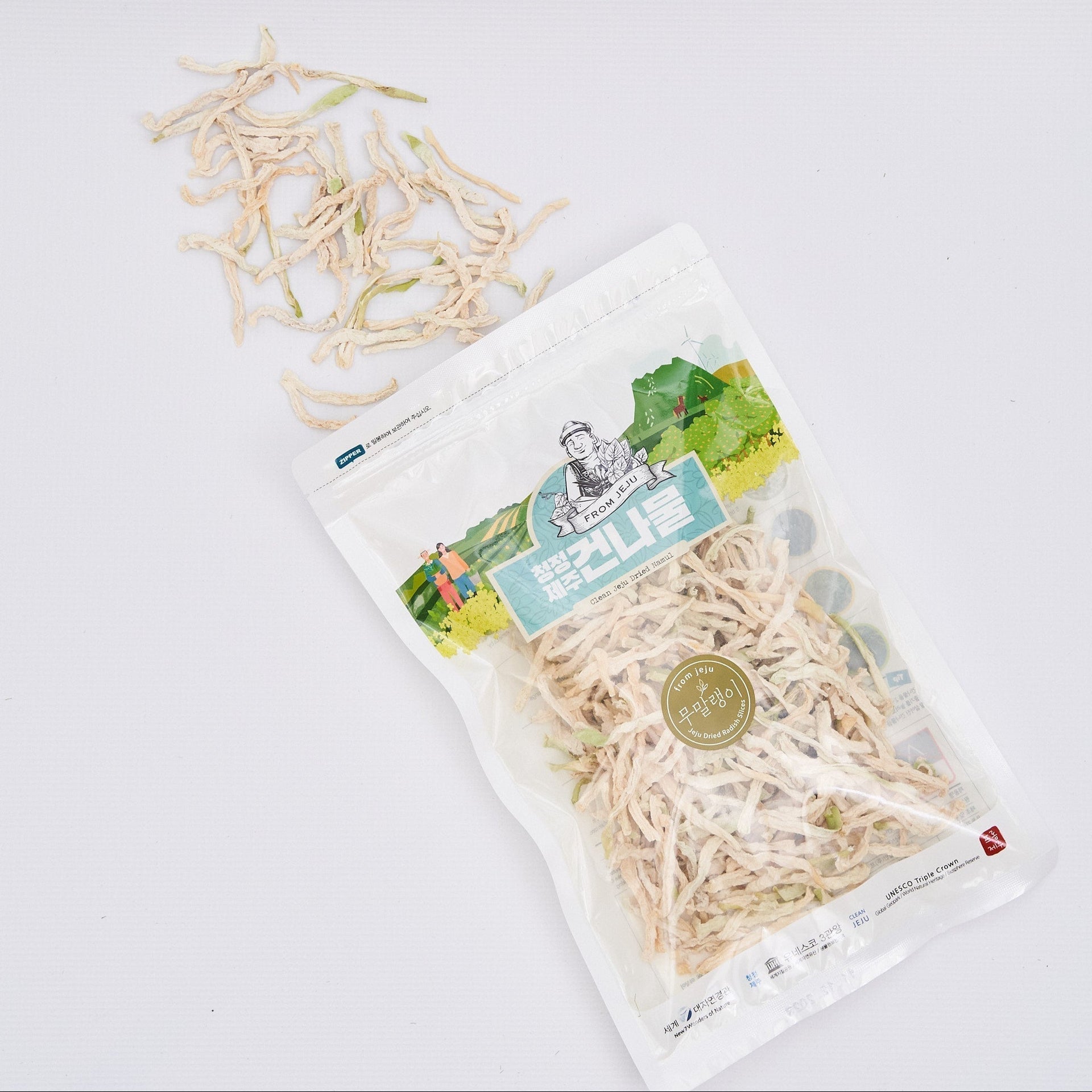 Dried radish slices pouch with pale dried strips and loose strands beside it
