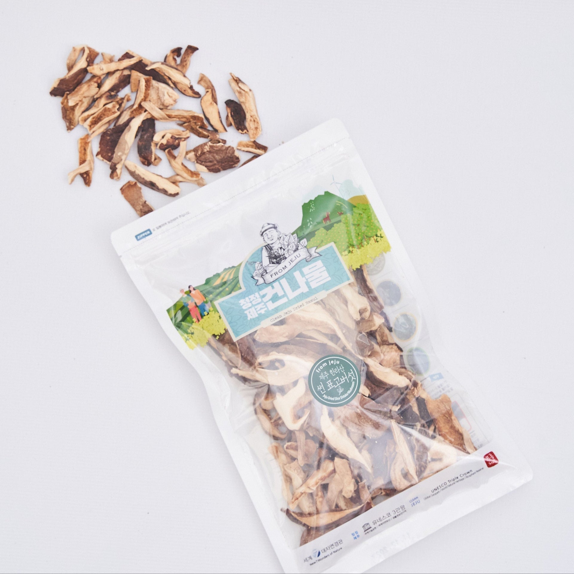 Dried thistle roots and stems in sealed pouch with mixed brown pieces on top