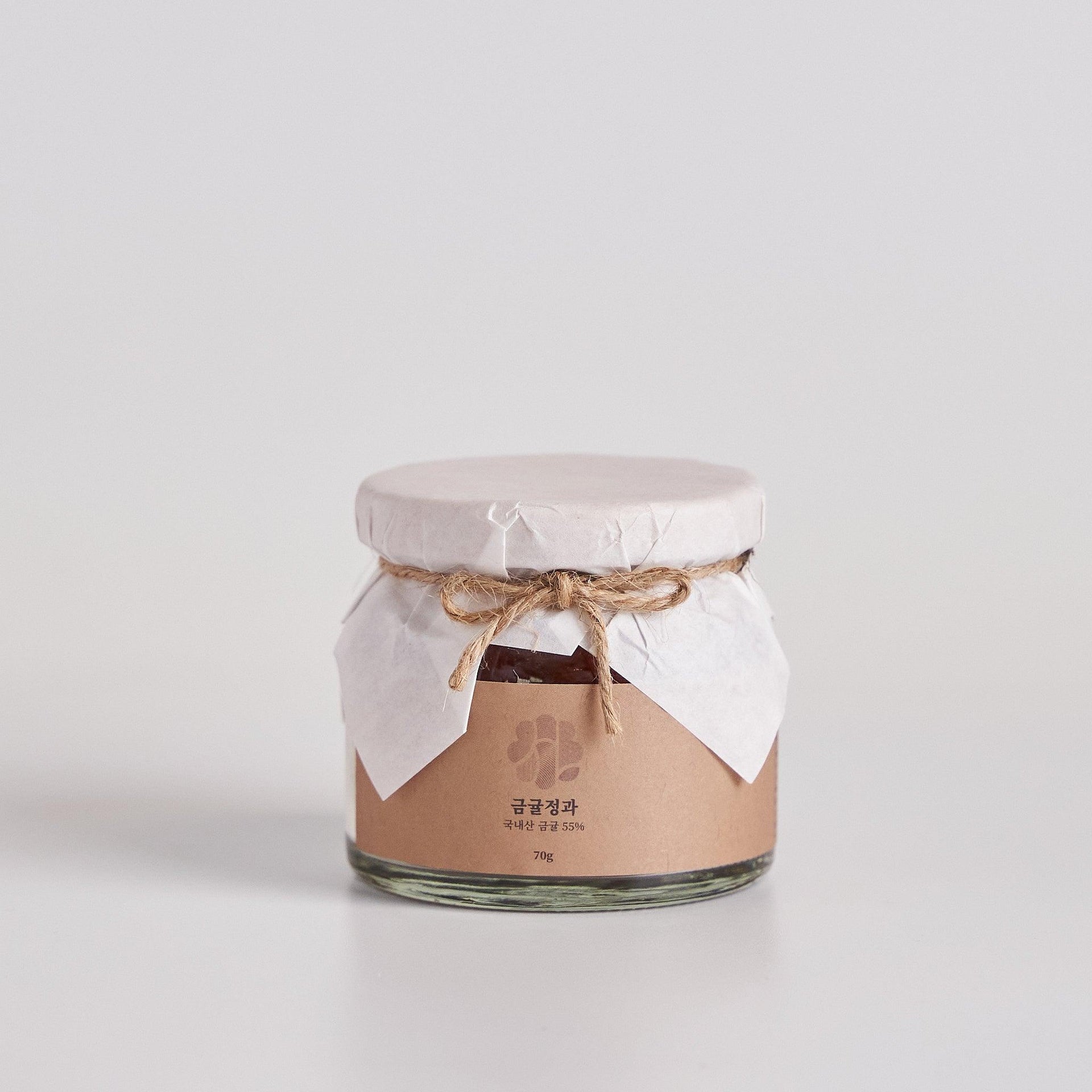 Dried kumquat jelly jar with sealed lid and tied ribbon