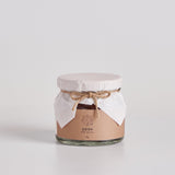 Dried kumquat jelly jar with sealed lid and tied ribbon