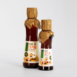 Sprouted sesame oil bottles with burlap-tied caps and front labels, two-pack view