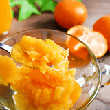 Tangerine juice pulp in a clear glass bowl