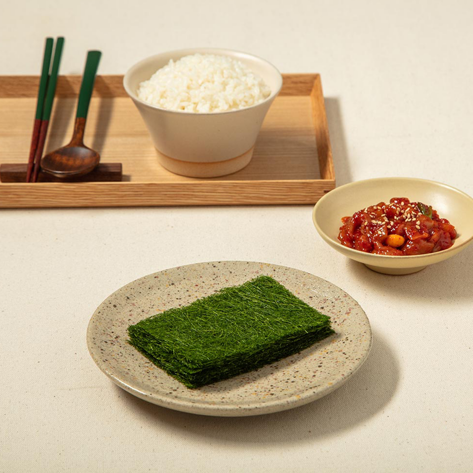 Gamtae seaweed sheet in bowl, green square on speckled plate