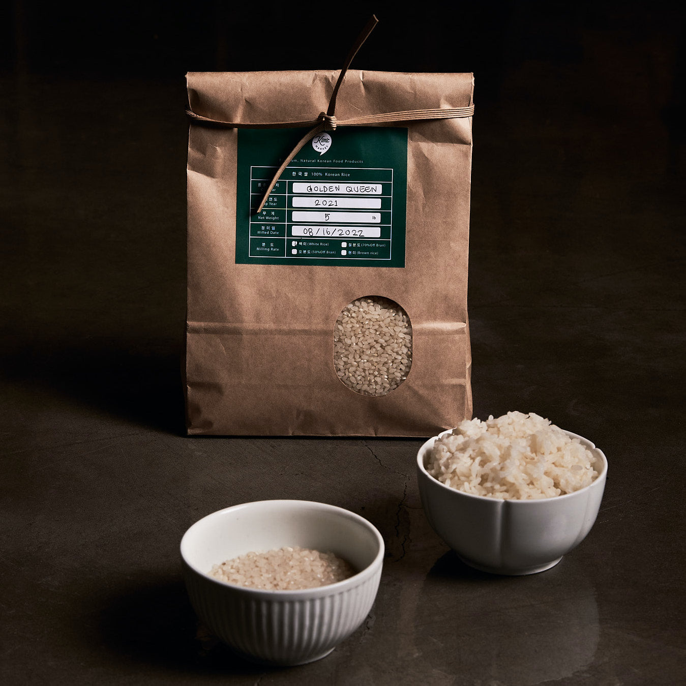 Korean rice bag with green label and rice-filled window, plus white rice in bowls