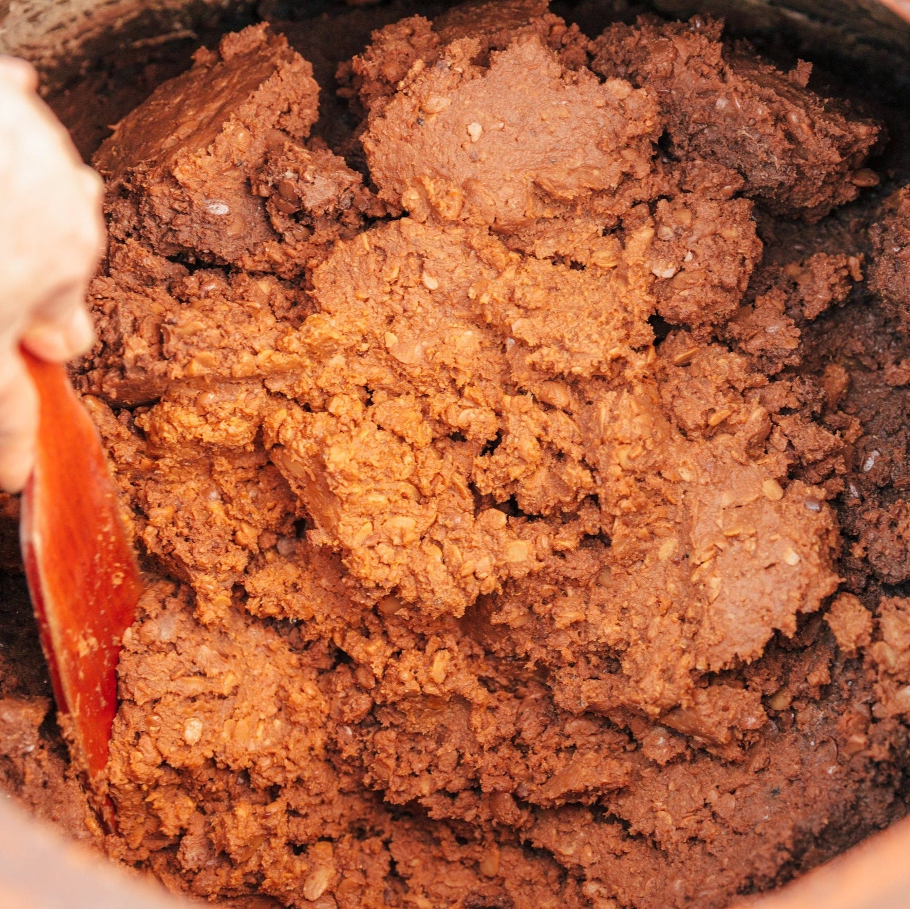 Dark brown doenjang soybean paste with coarse chunks in a bowl