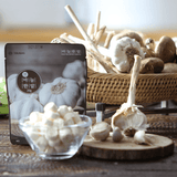 Packaged chopped garlic tablets with garlic bulbs on woven basket