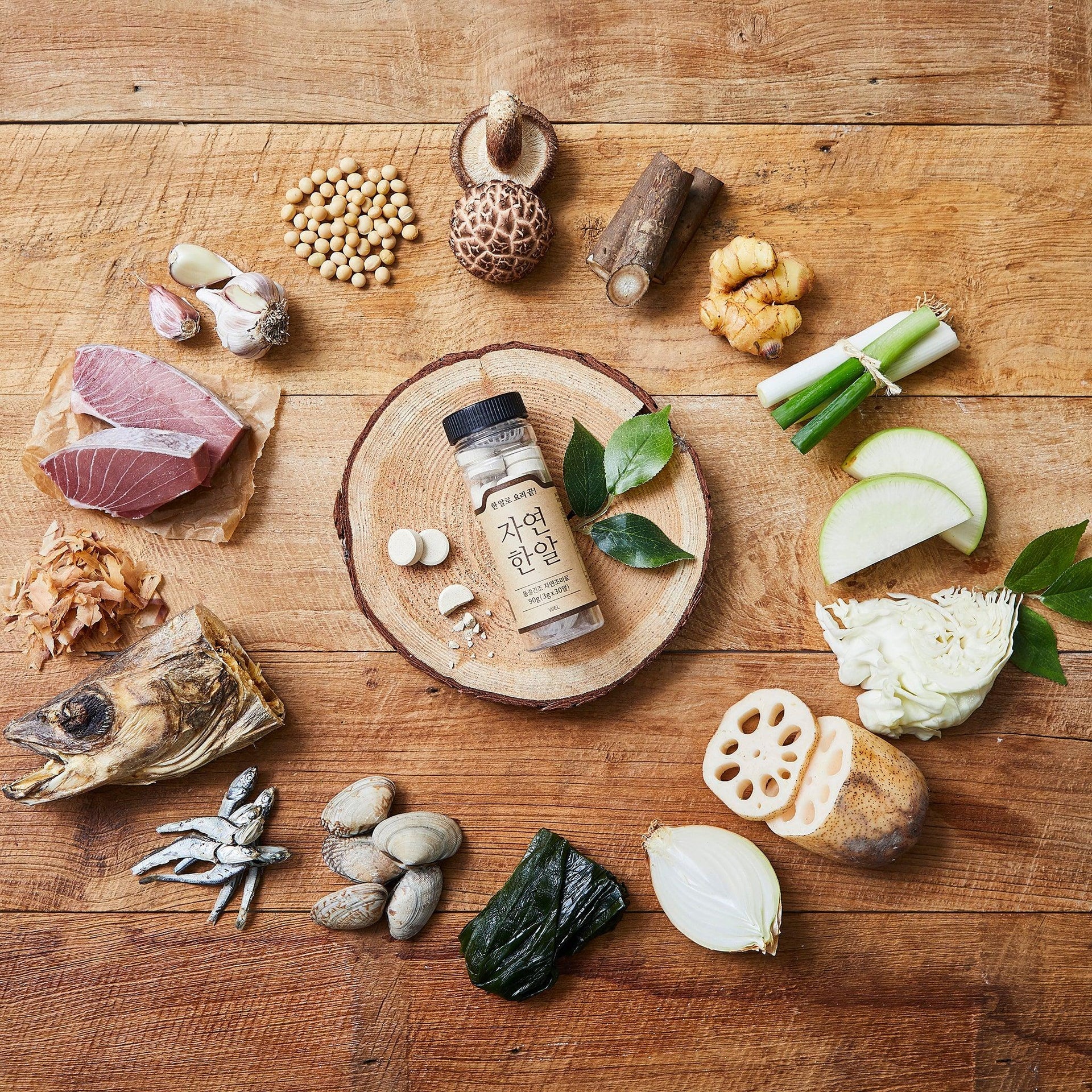 Natural seafood stock tablets bottle surrounded by seafood, mushrooms, and vegetables