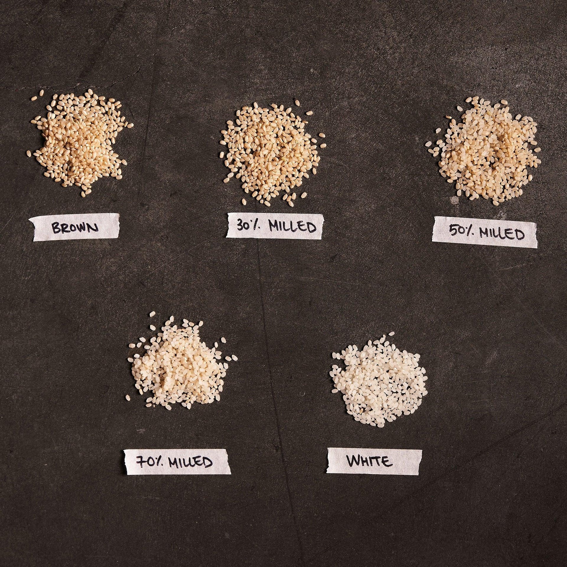 Milled Korean rice sample assortment: brown, 30%, 50%, 70% and white rice piles
