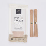 Hand pulled noodle pouch with pale pinkish-beige uncooked noodles, two bundles