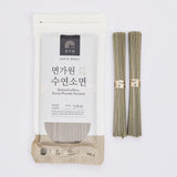 Hand pulled noodle pouch with grayish uncooked noodles, two bundles